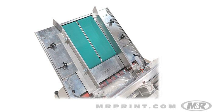 Infeed chute with belt-driven system delivers shirts quickly and accurately to the bag