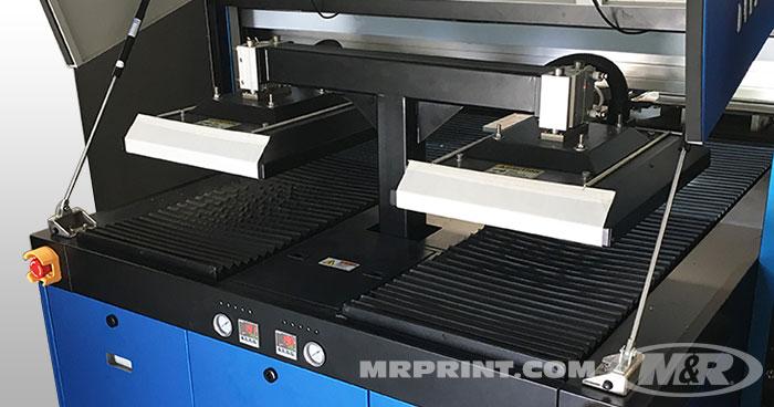 Built-in heat presses flatten fibers and heat garment surfaces prior to printing